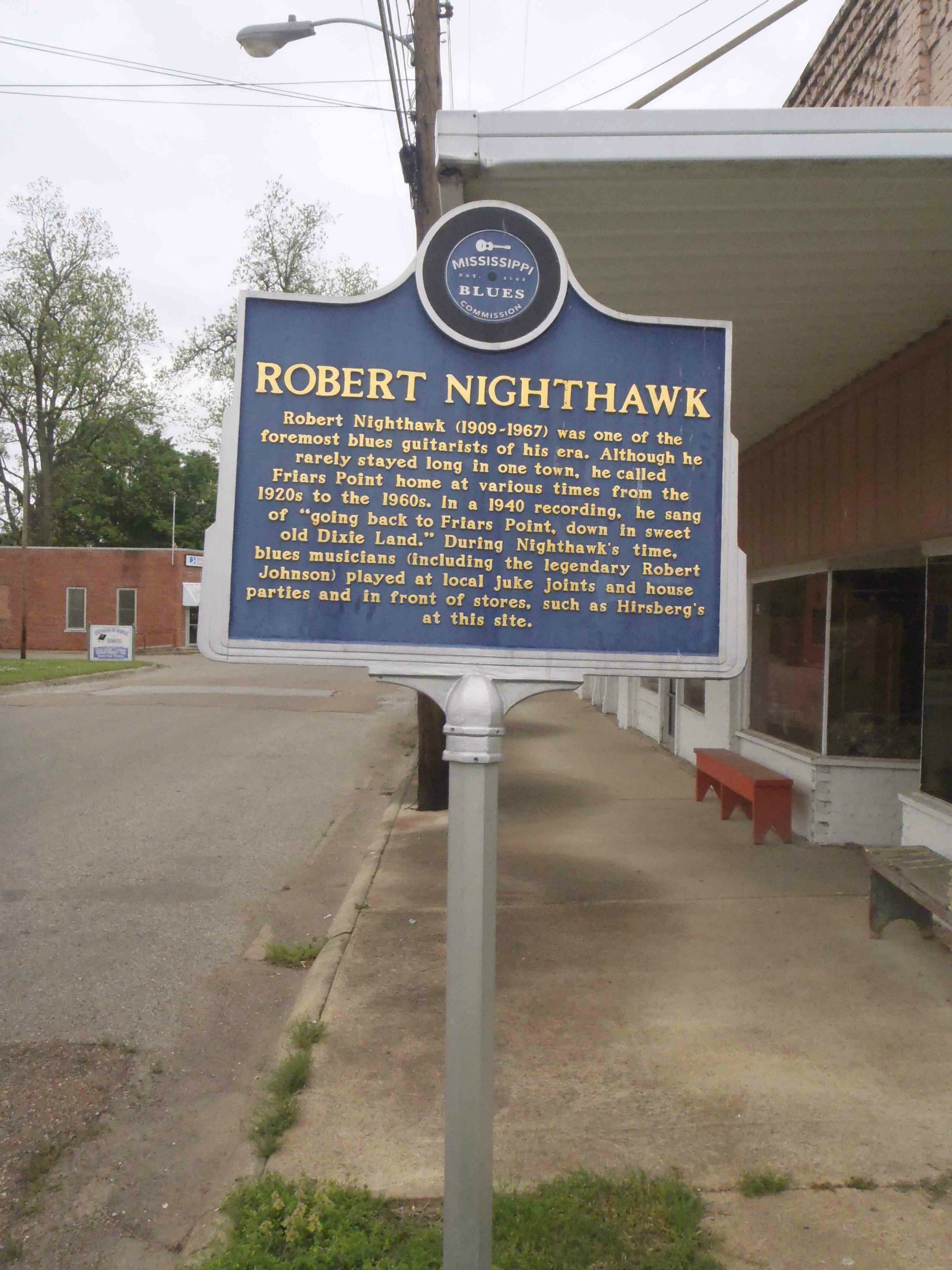 The Mississippi Blues Trail marker for Robert Nighthawk, outside the building that was once Hirsbergs Drug Store in Friars Point, Mississippi