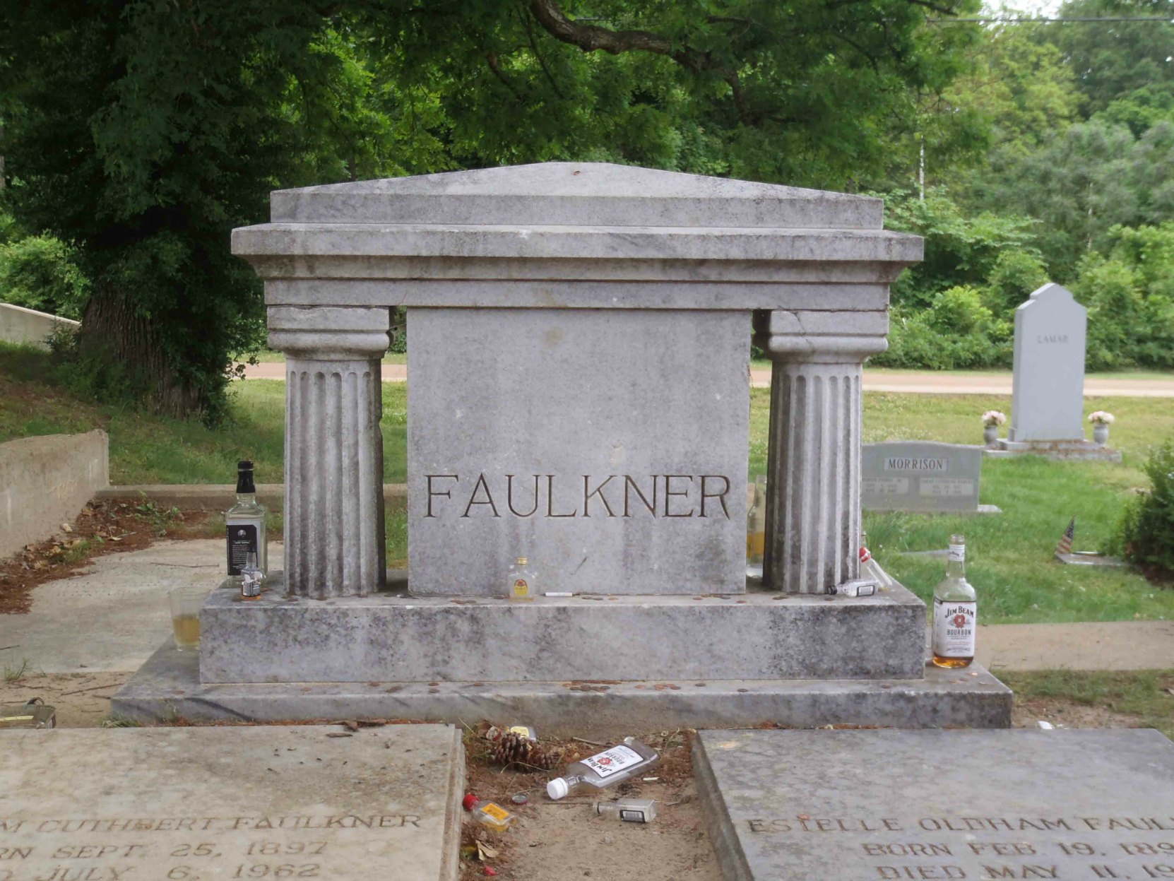 William Faulkner's grave in Oxford, Mississippi. The liquor bottles are tributes left at the grave by William Faulkner's fans.